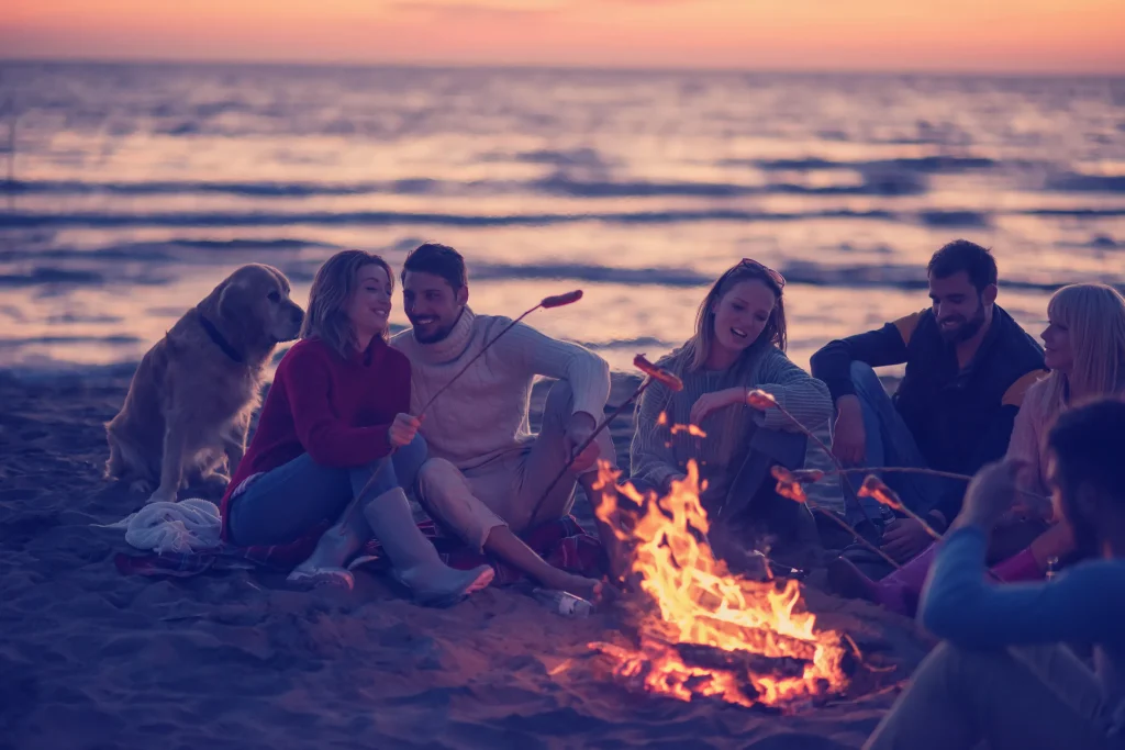 The boys and girls celebrate the summer beach bonfire party