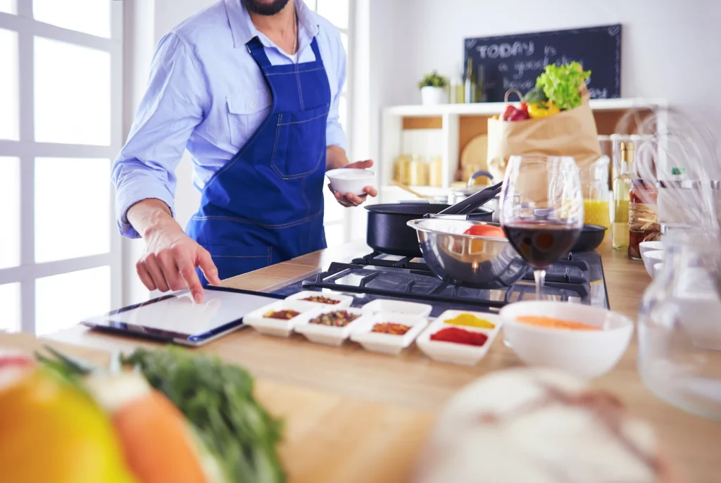 A man participates the virtual cooking class and try to cook 